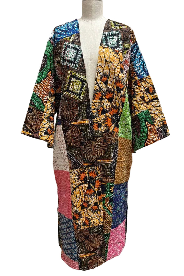 Colorful patchwork coat on a mannequin against a white background